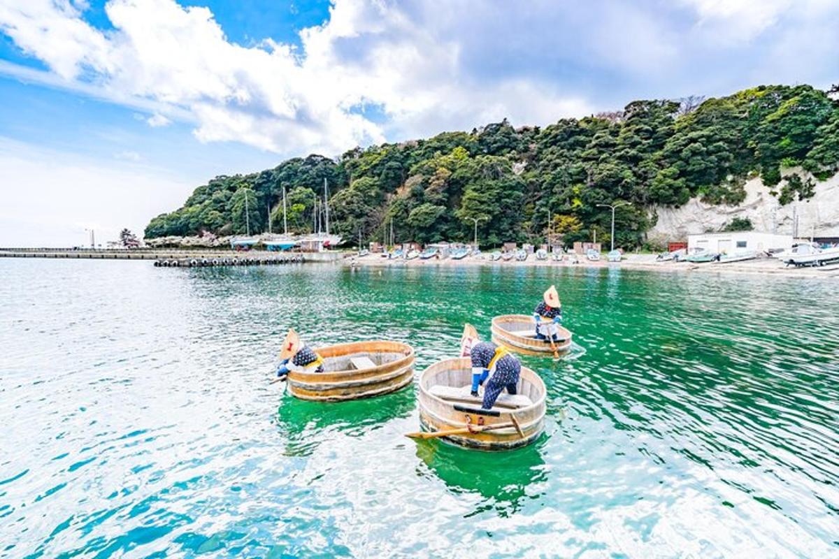 two small boats in the water near a beach
