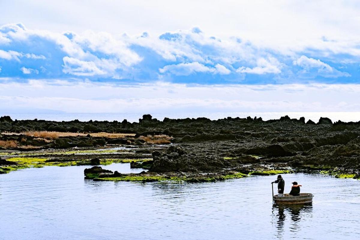 two people in a small boat in the water