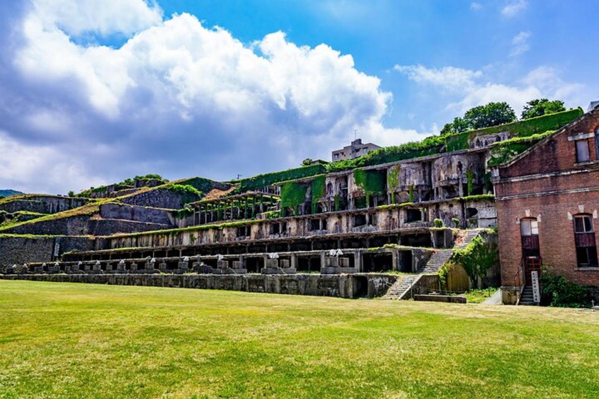 an old building with a grass field in front of it