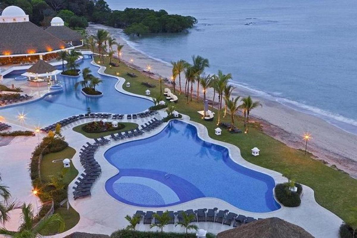 an aerial view of a resort near the beach