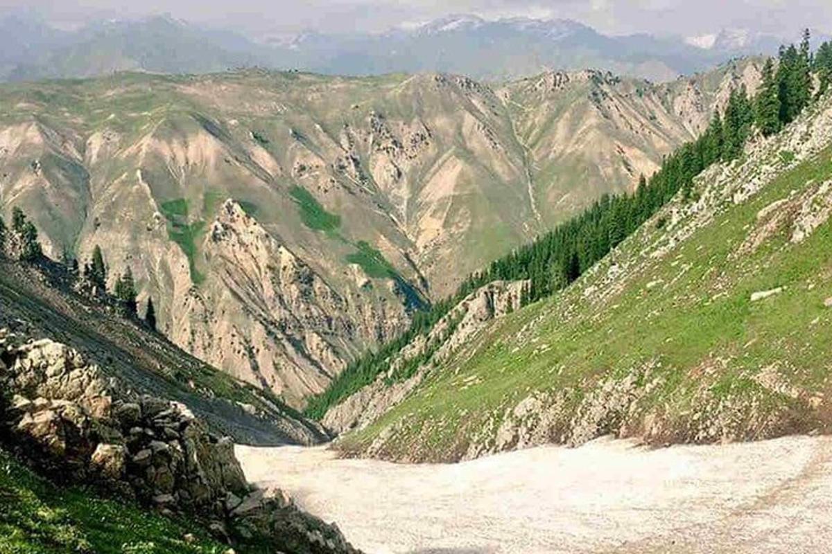 a view of a mountain with a river in it