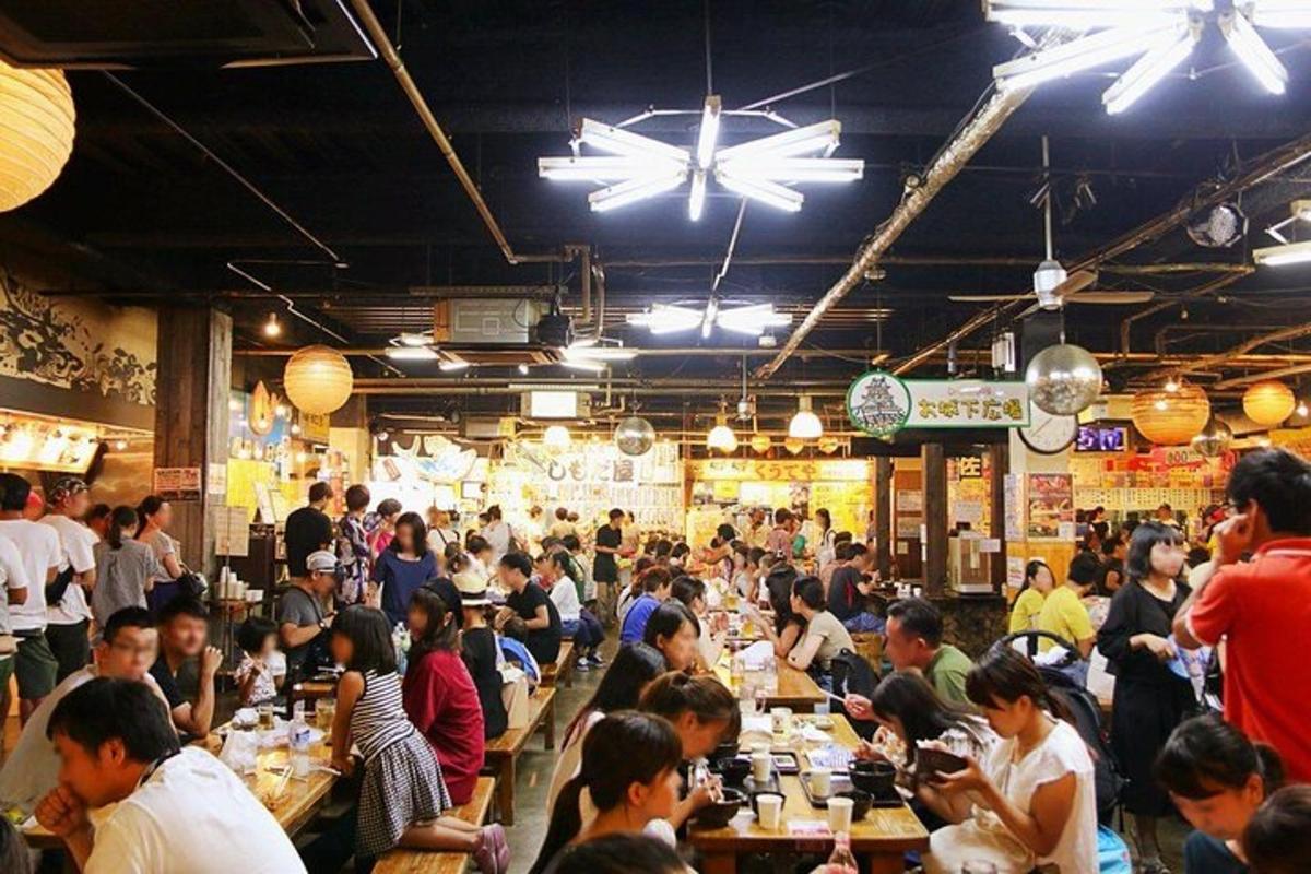 a crowd of people sitting at tables in a restaurant