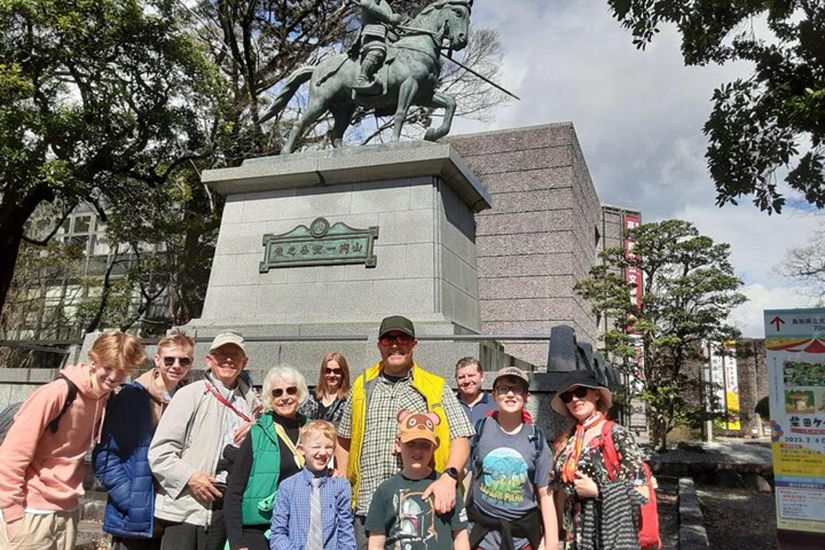 a group of people standing in front of a statue