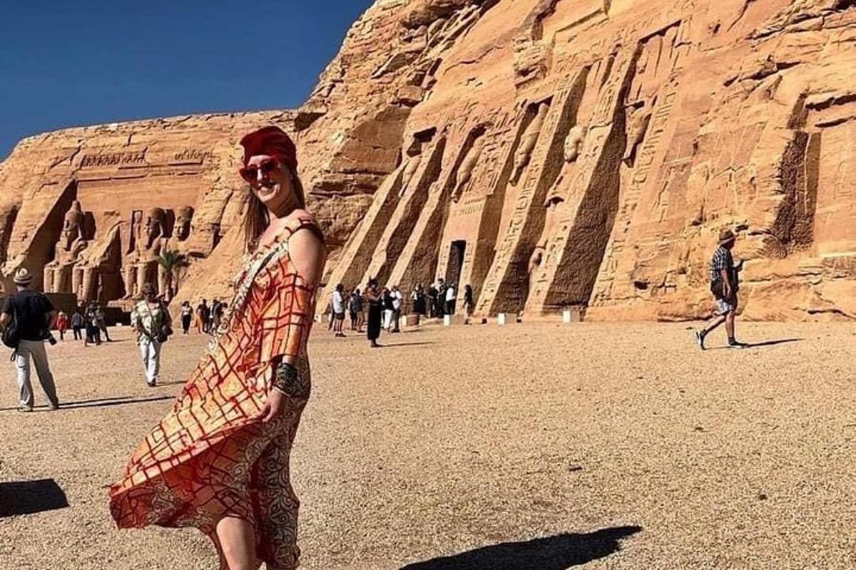 a woman is standing in front of a mountain