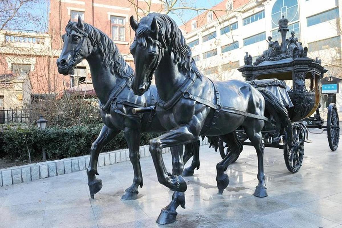 a statue of a horse pulling a carriage