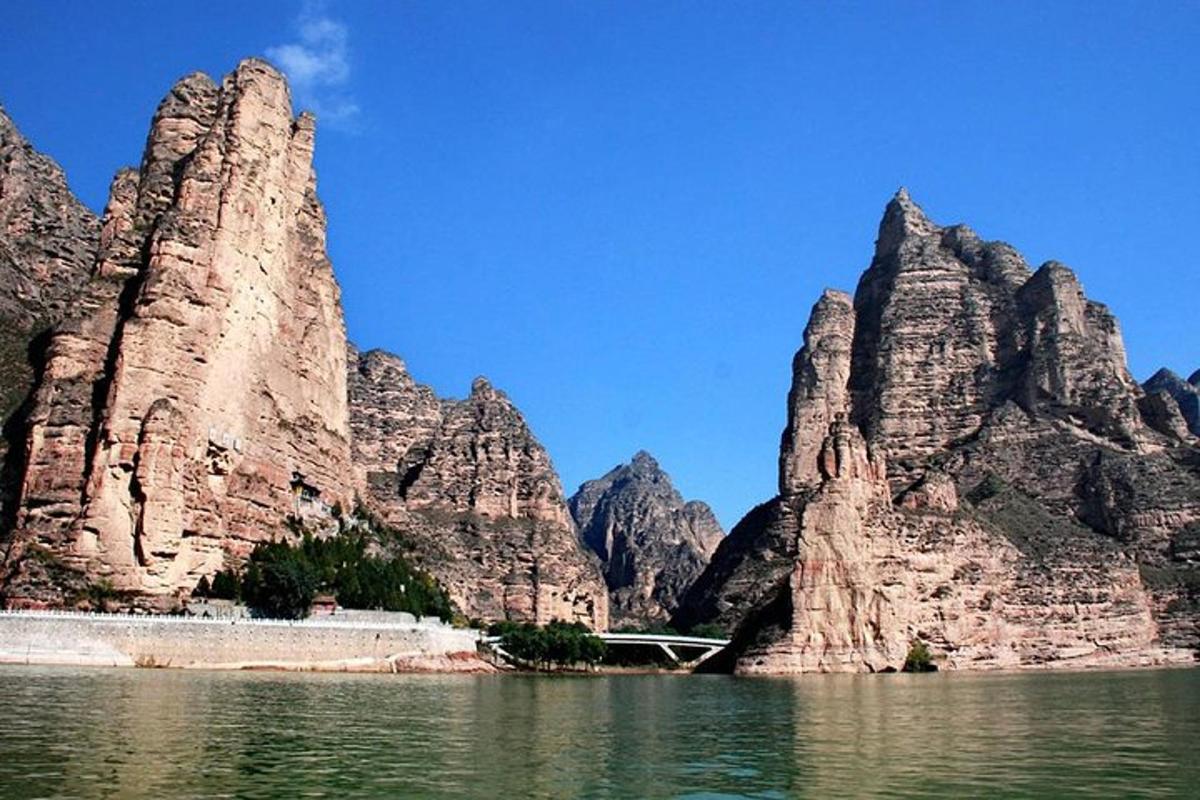 a view of a mountain from the water