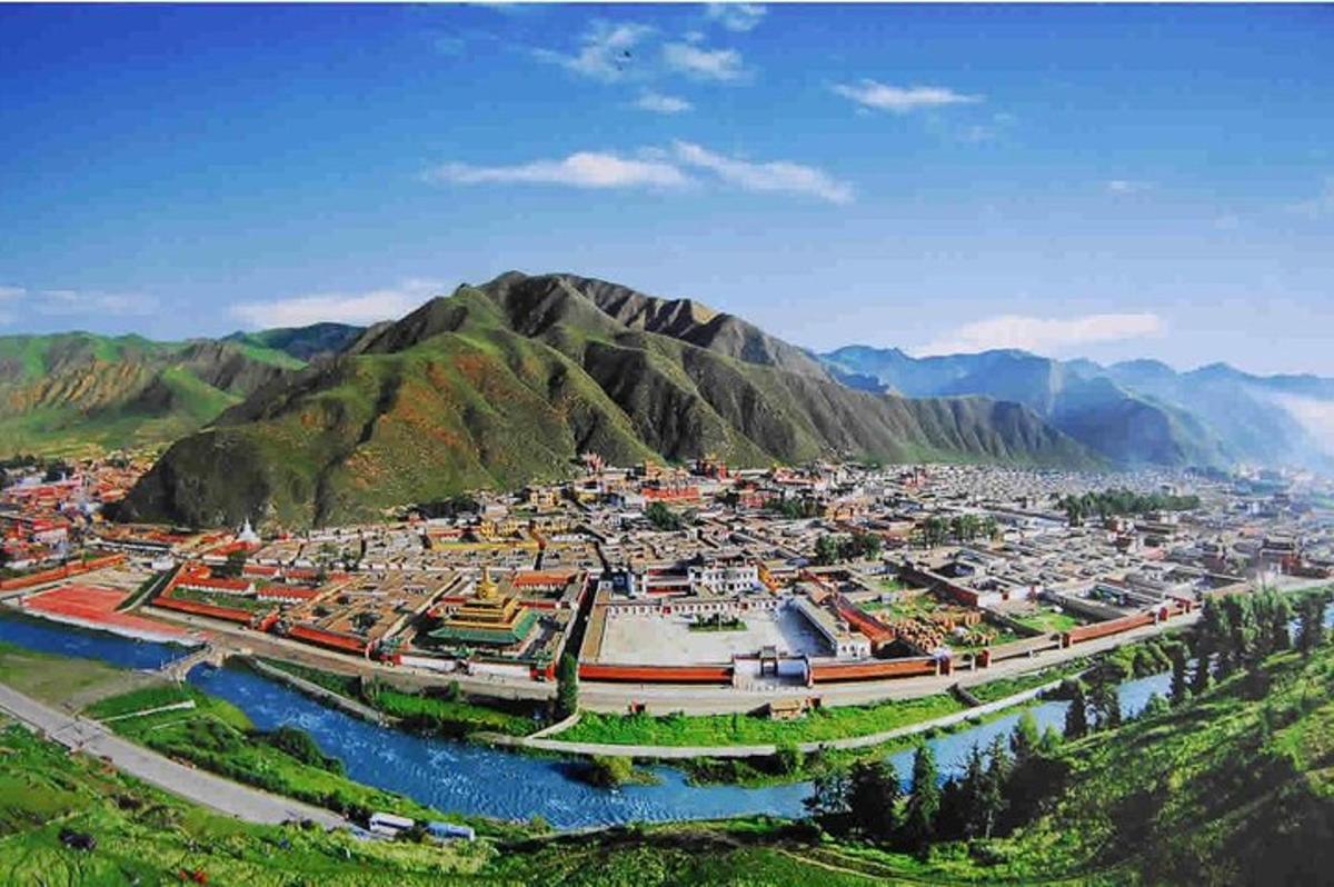 an aerial view of a city with mountains in the background