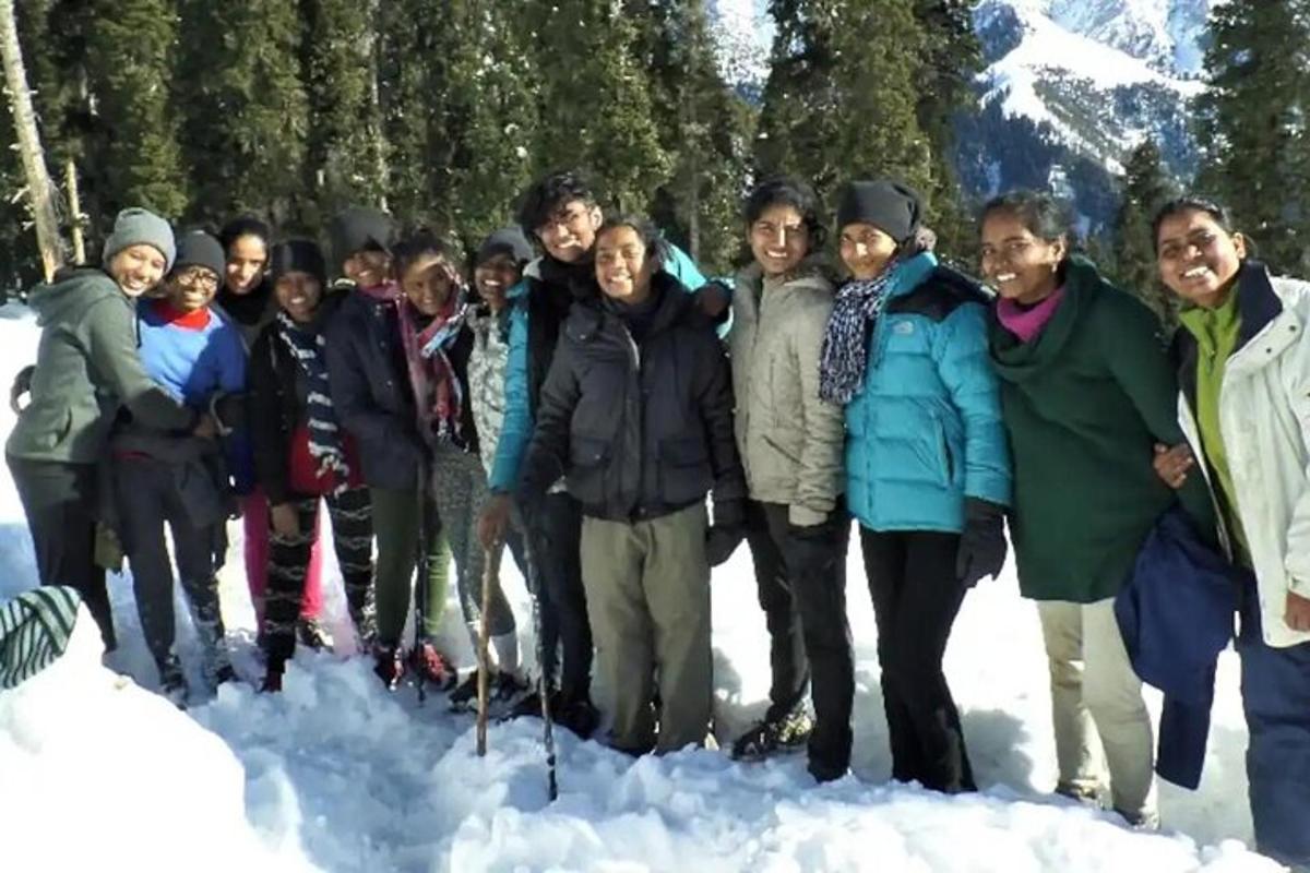 a group of people standing in the snow
