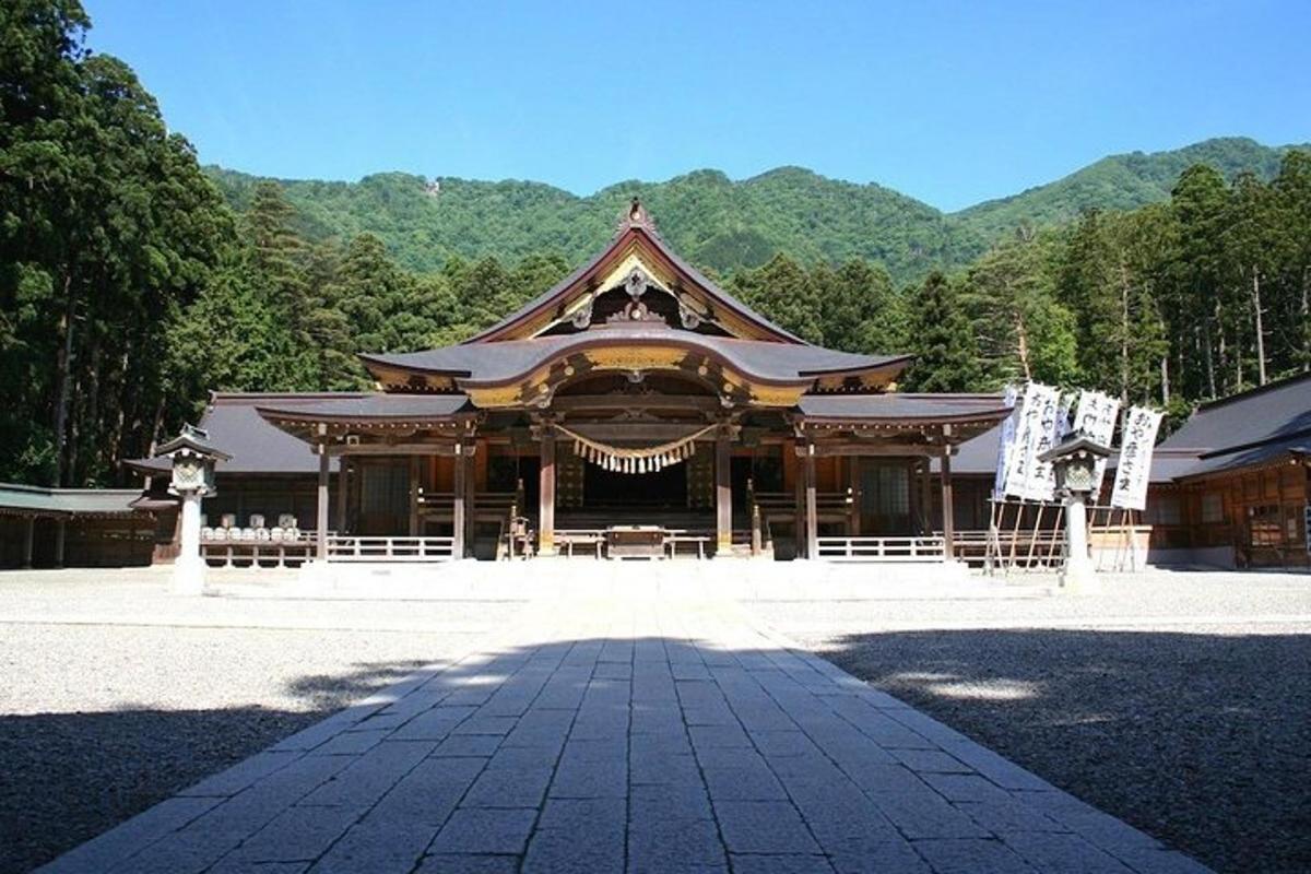 a large building with a mountain in the background