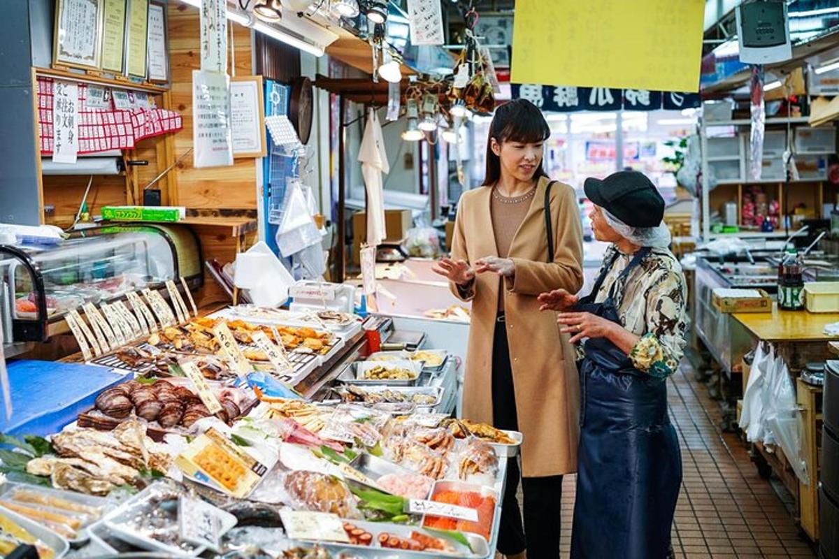 a woman standing in a grocery store talking to a customer