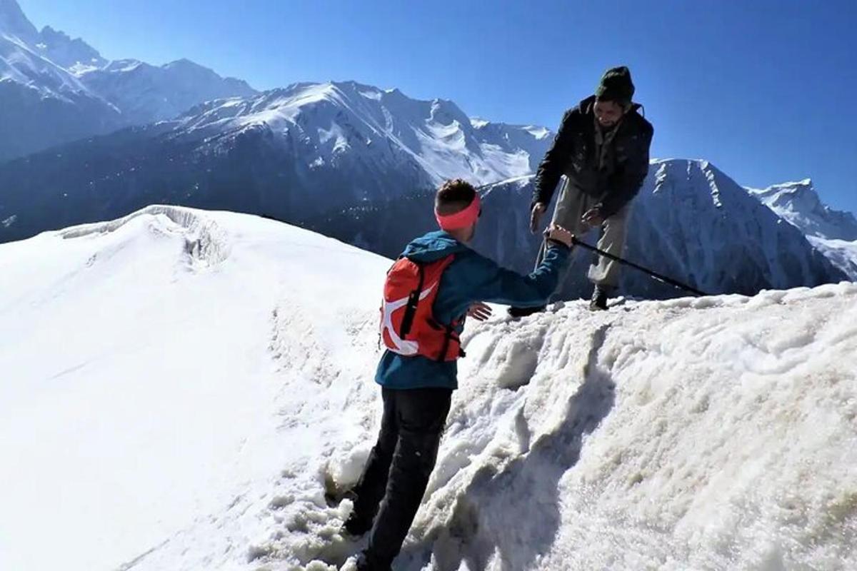 two people standing on top of a snow covered mountain