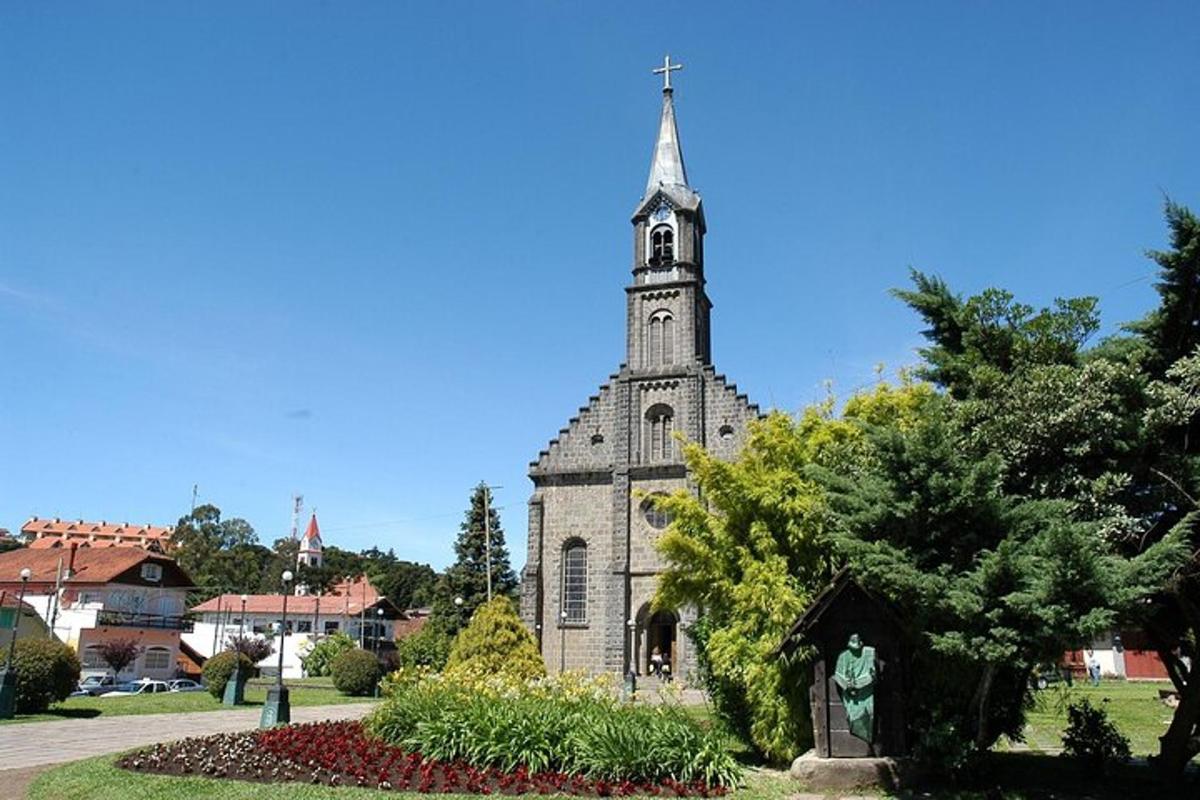 an old church with a tower in a park