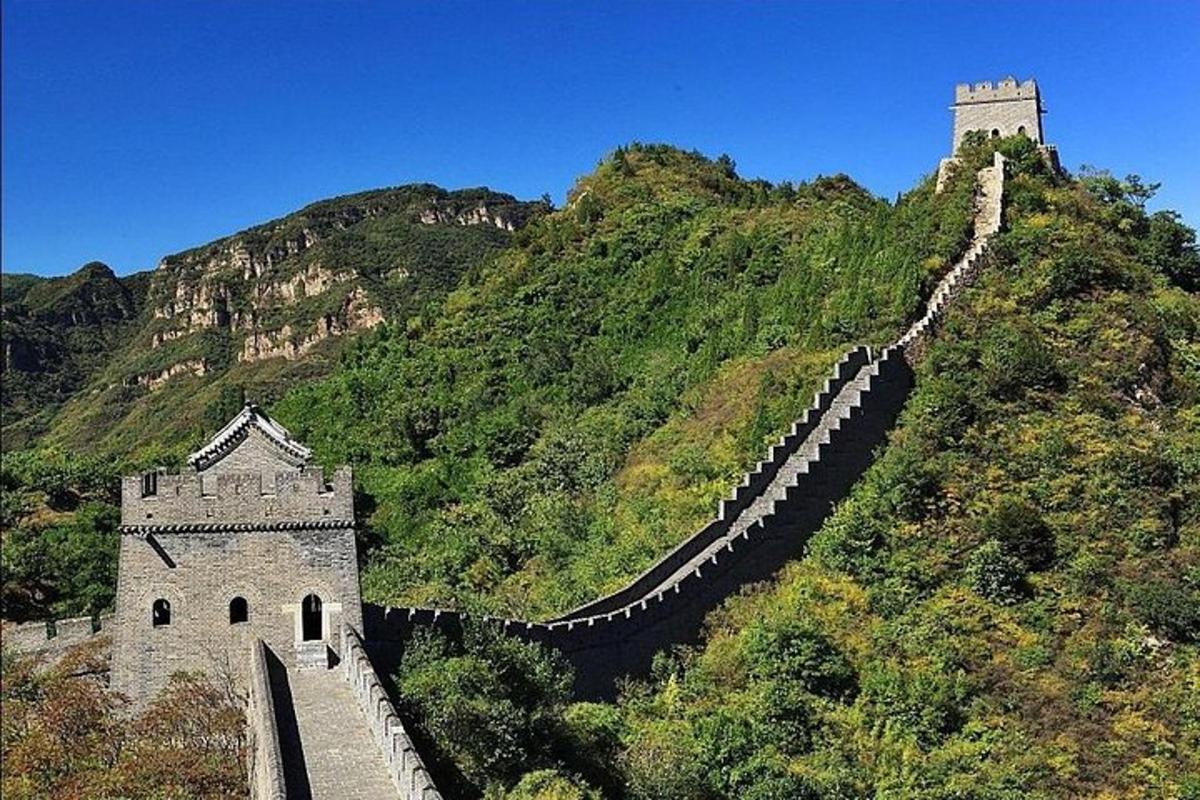 a building on top of a mountain with a wall