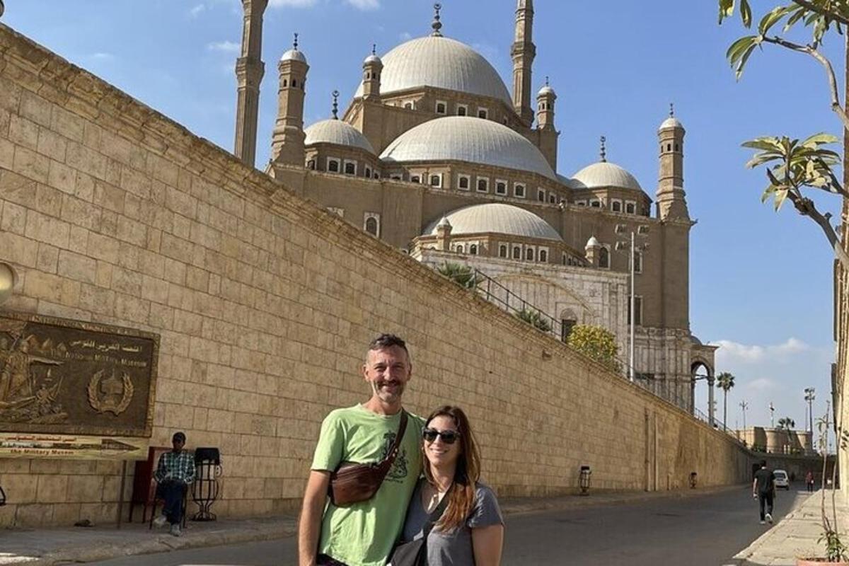 a man and a woman standing in front of a building
