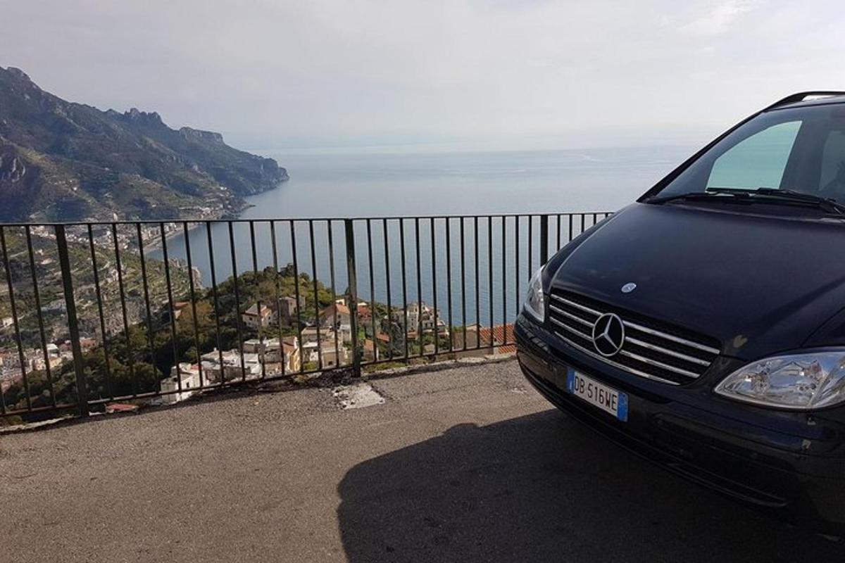 um carro estacionado na encosta de uma colina com vista para o oceano
