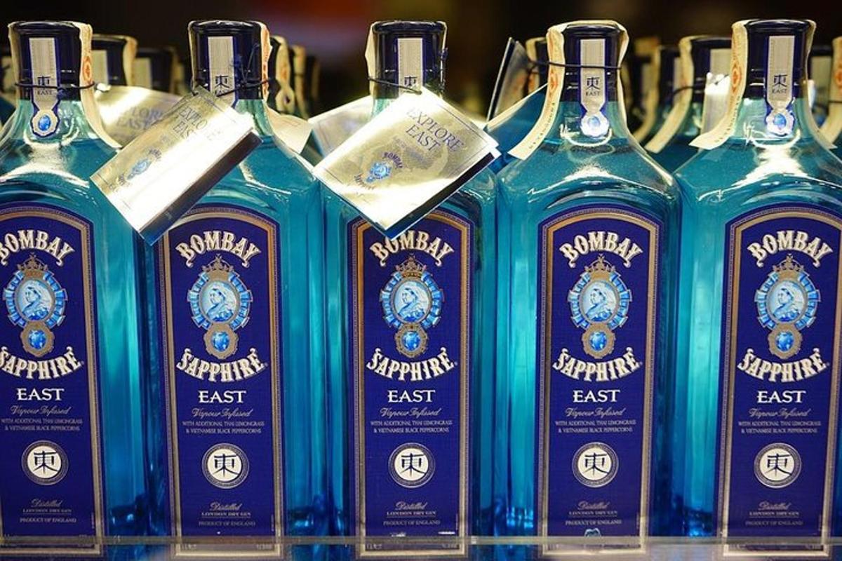 a group of bottles of blue bottles of gin on a shelf