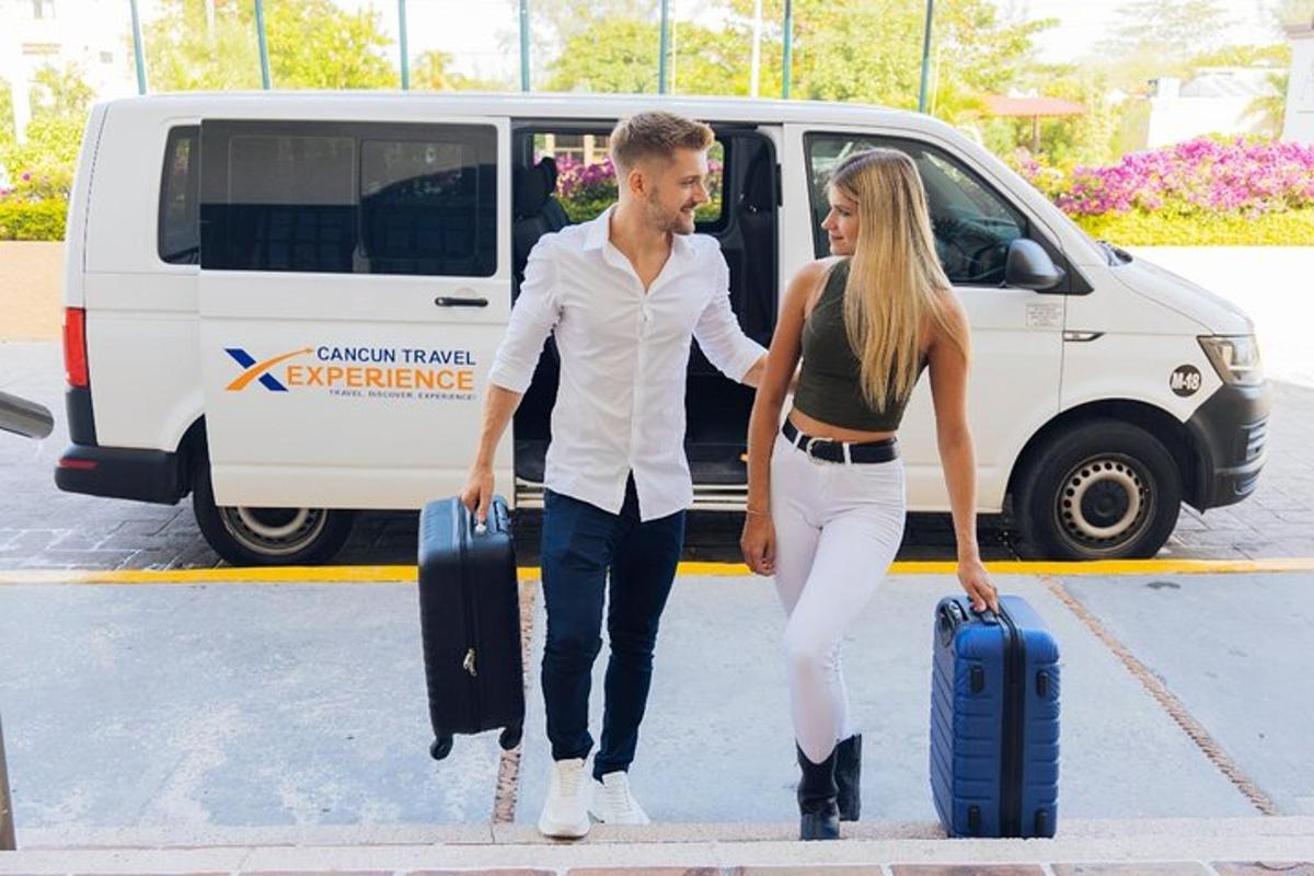 a man and a woman walking with luggage in front of a van