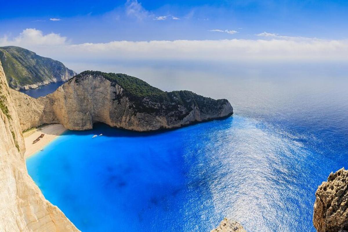 an aerial view of a beach with blue water