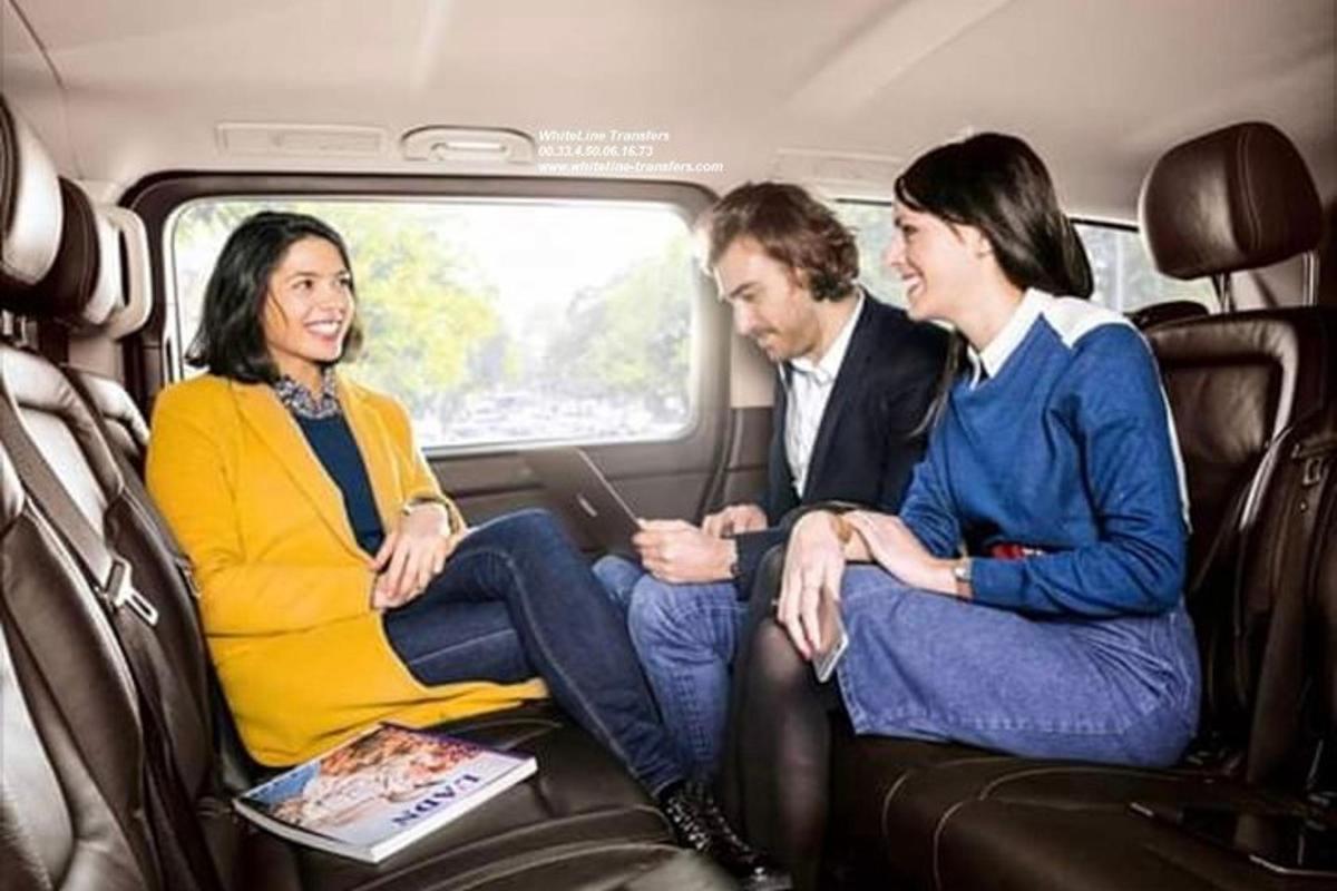 a group of three people sitting in a train