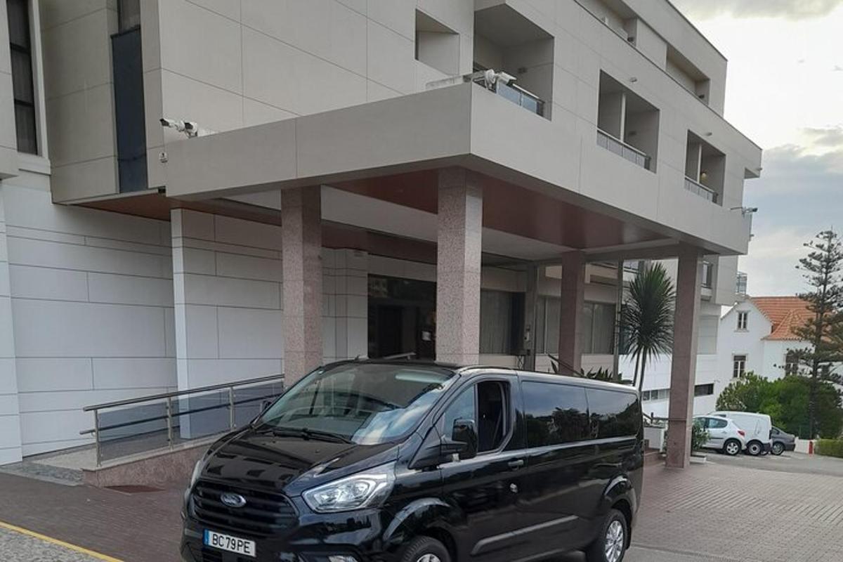 ένα μαύρο βαν παρκαρισμένο μπροστά από ένα κτίριο