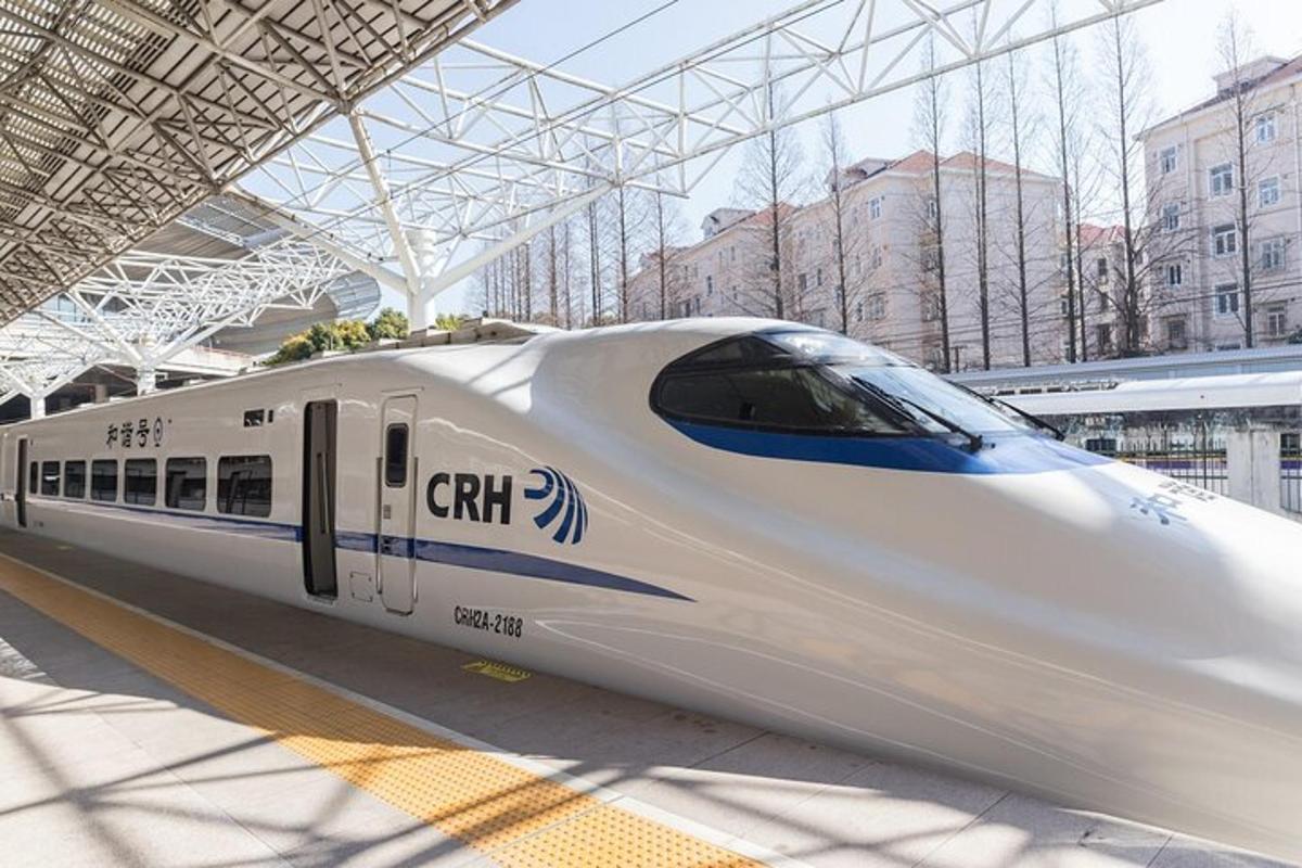 a white train is parked at a train station