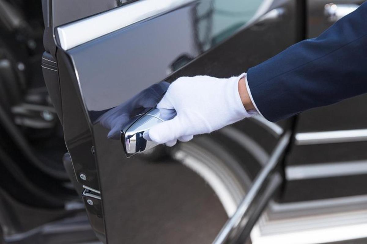 a person in a white glove is opening a machine