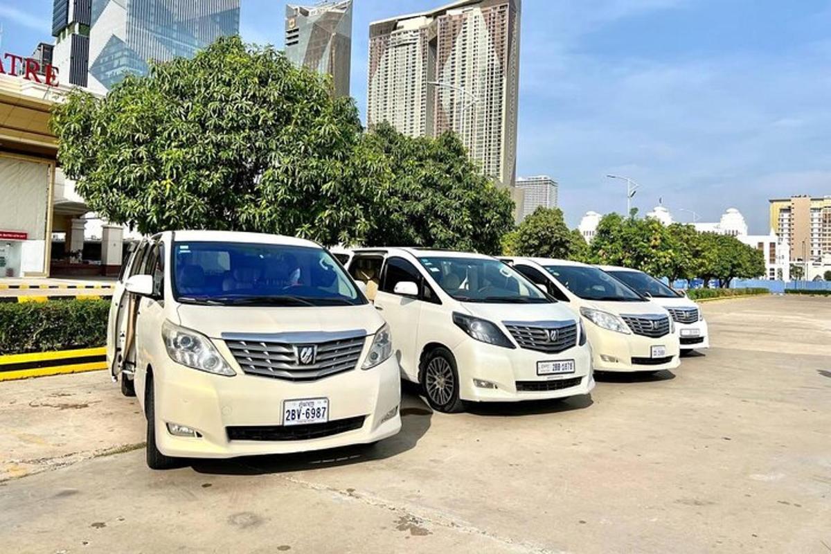 a row of white cars parked in a parking lot