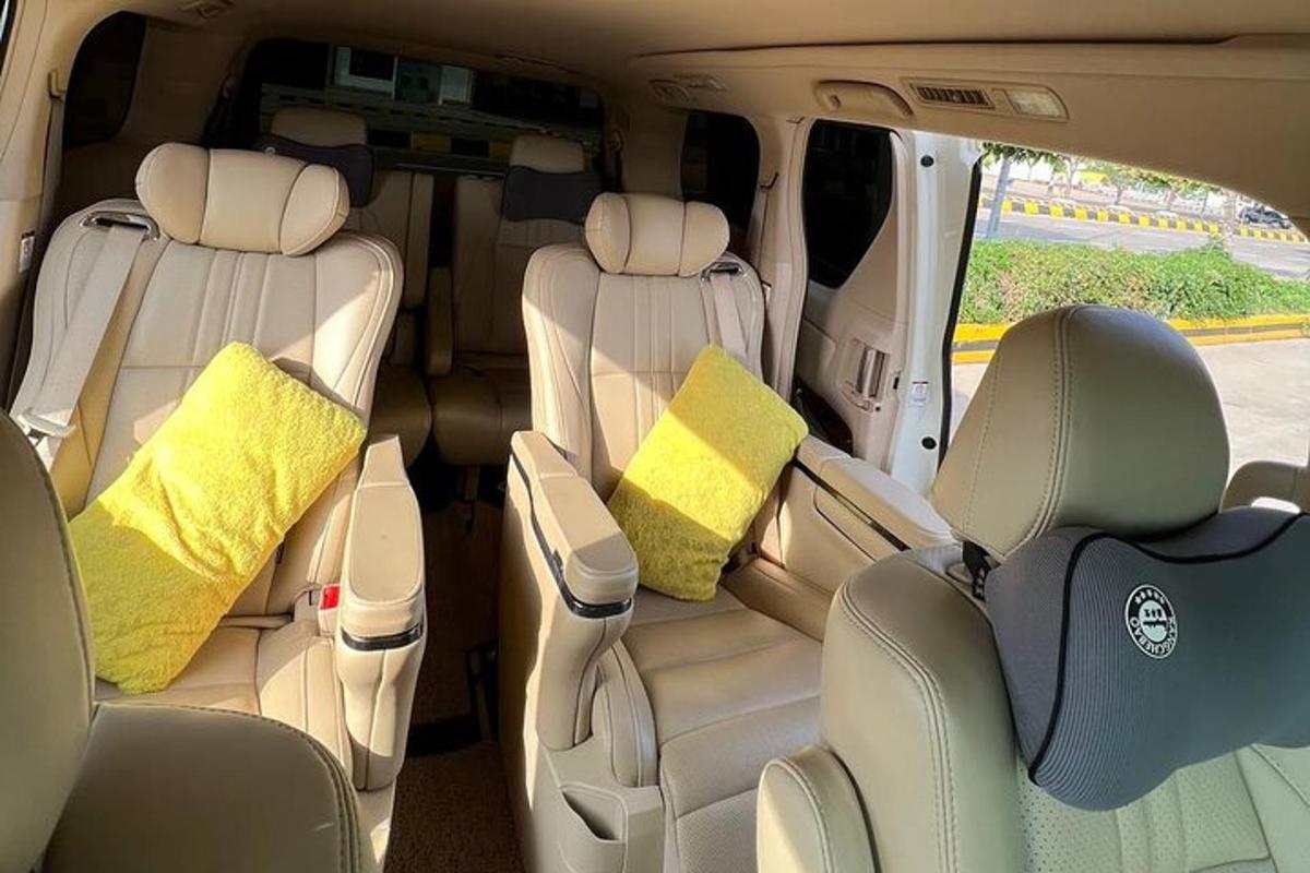 a rear seats of a van with yellow pillows