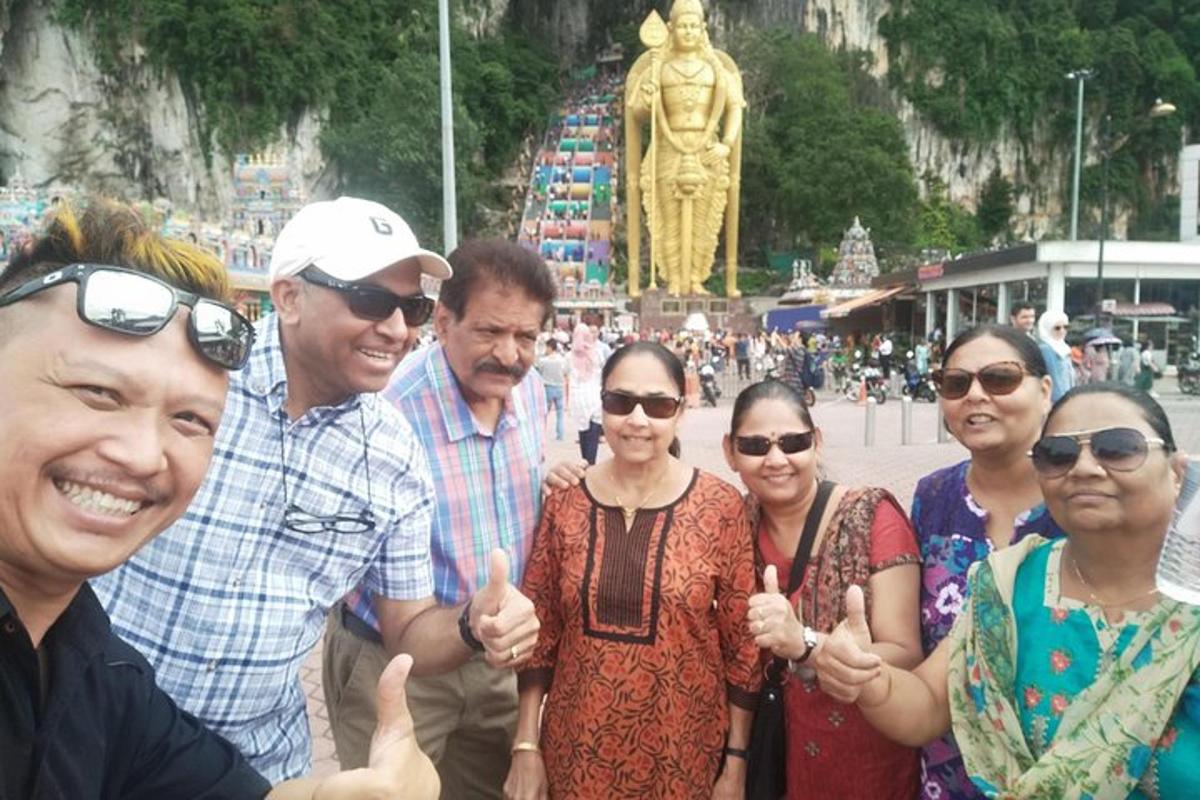 a group of people posing for a picture in front of a statue