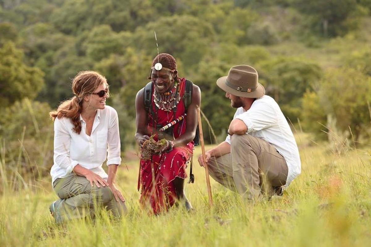 a group of three people standing in a field