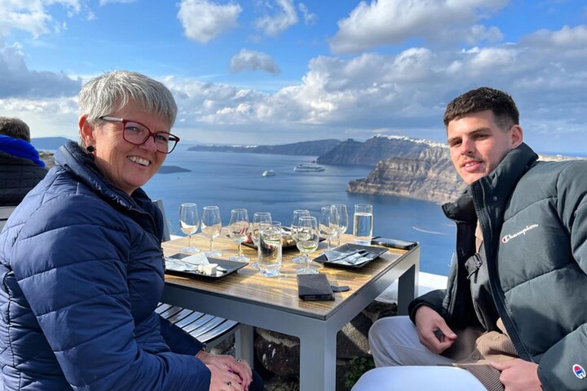 a man and a woman sitting at a table with wine glasses