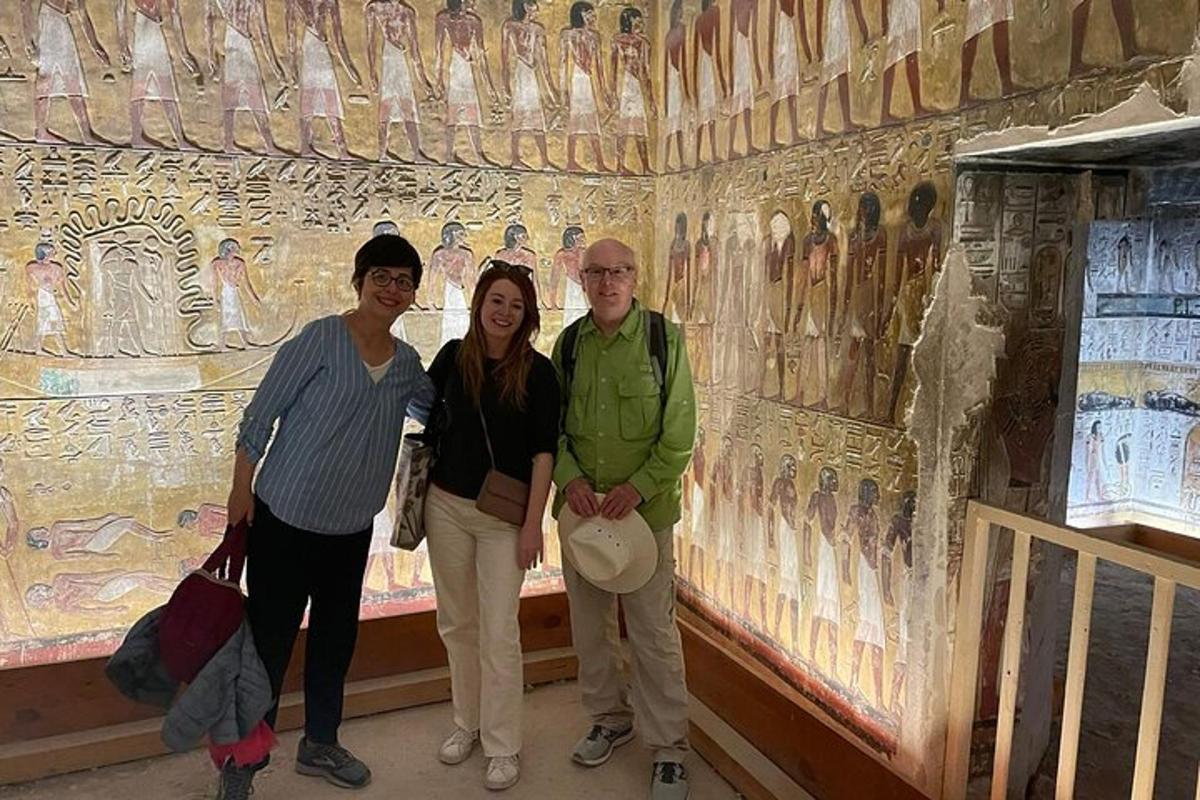 a group of people standing in front of a painting