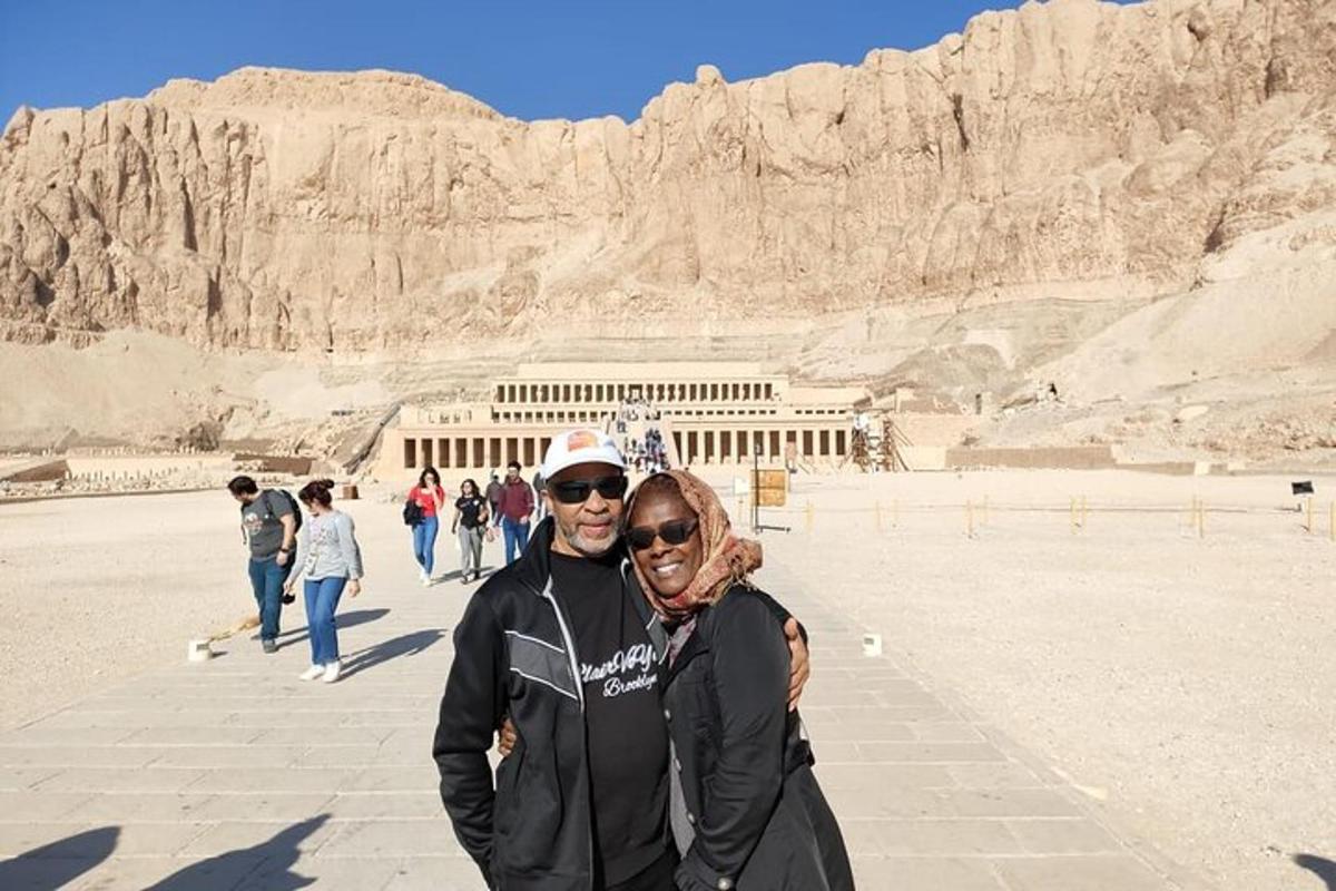 a man and a woman standing in front of a building
