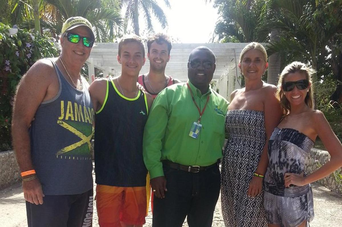 a group of people posing for a picture on the beach