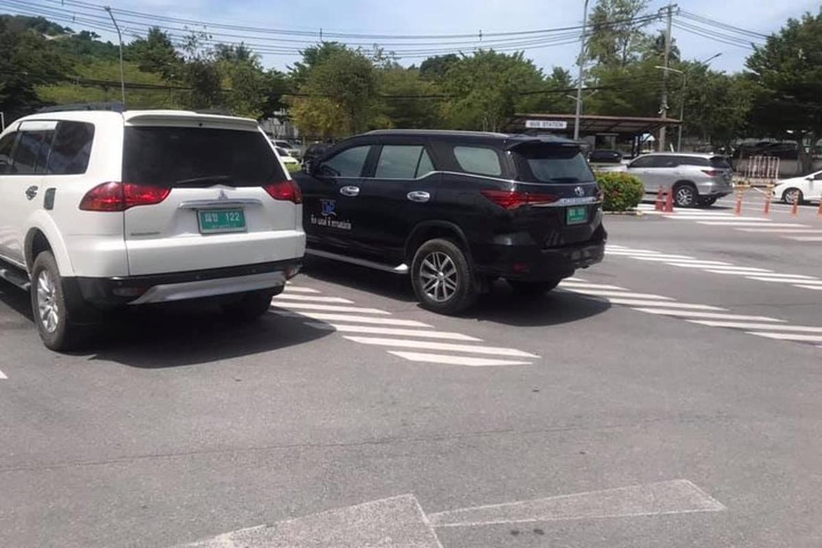 Dos coches están aparcados en un estacionamiento