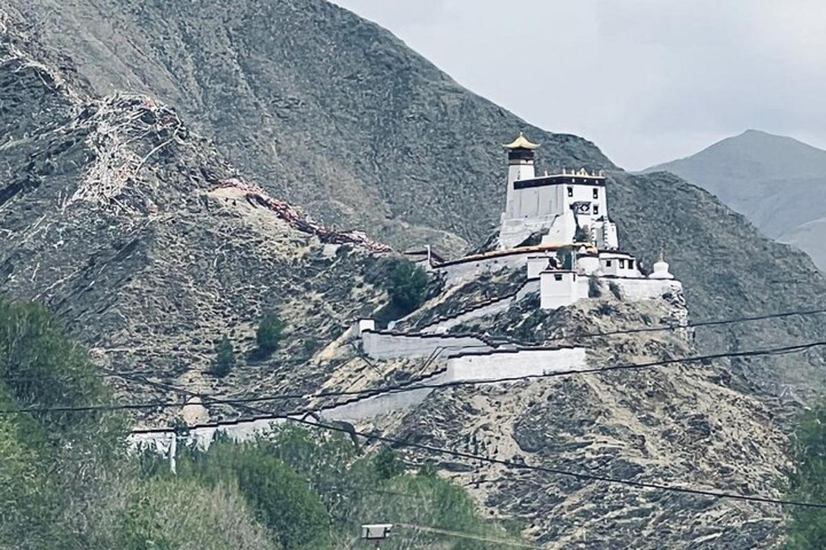 a white building on the side of a mountain