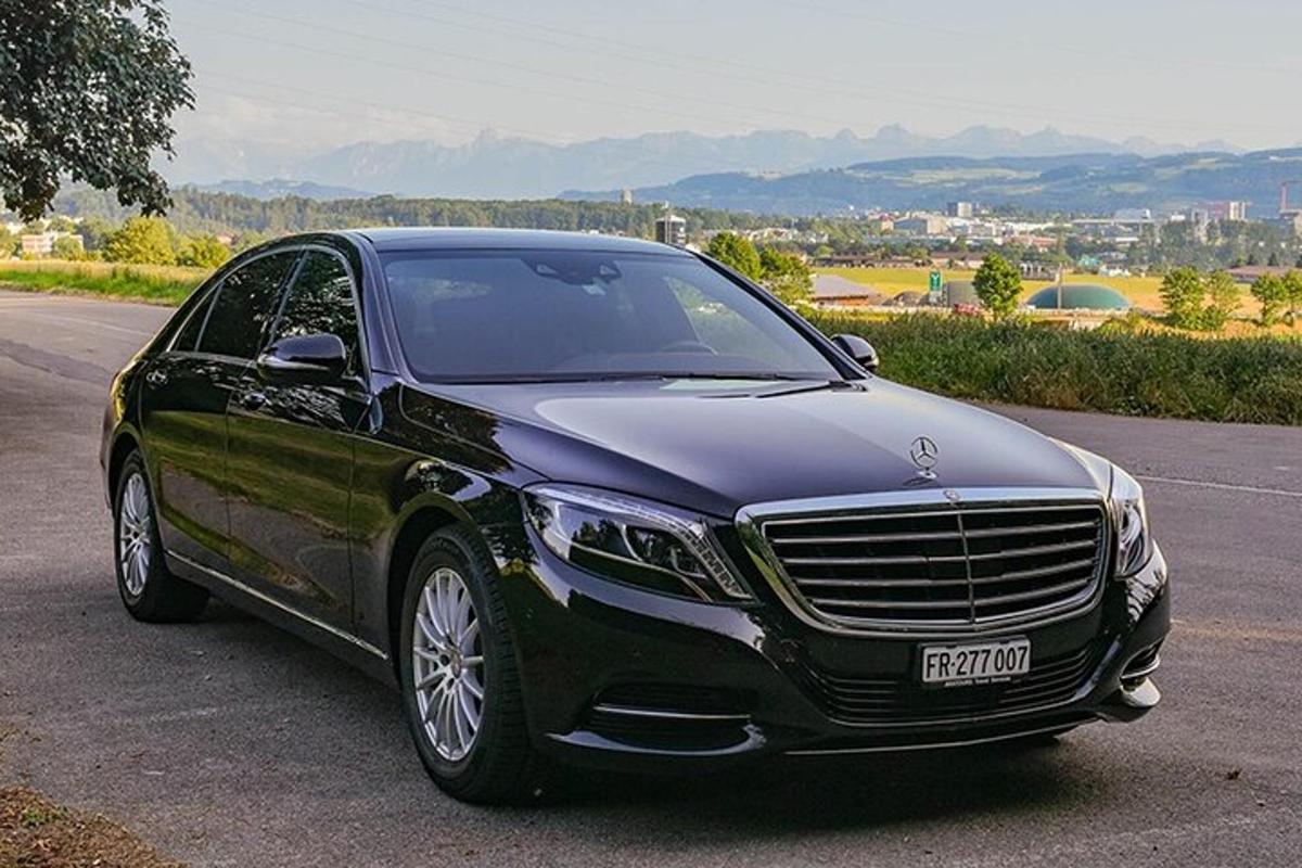 a black luxury car parked on a road