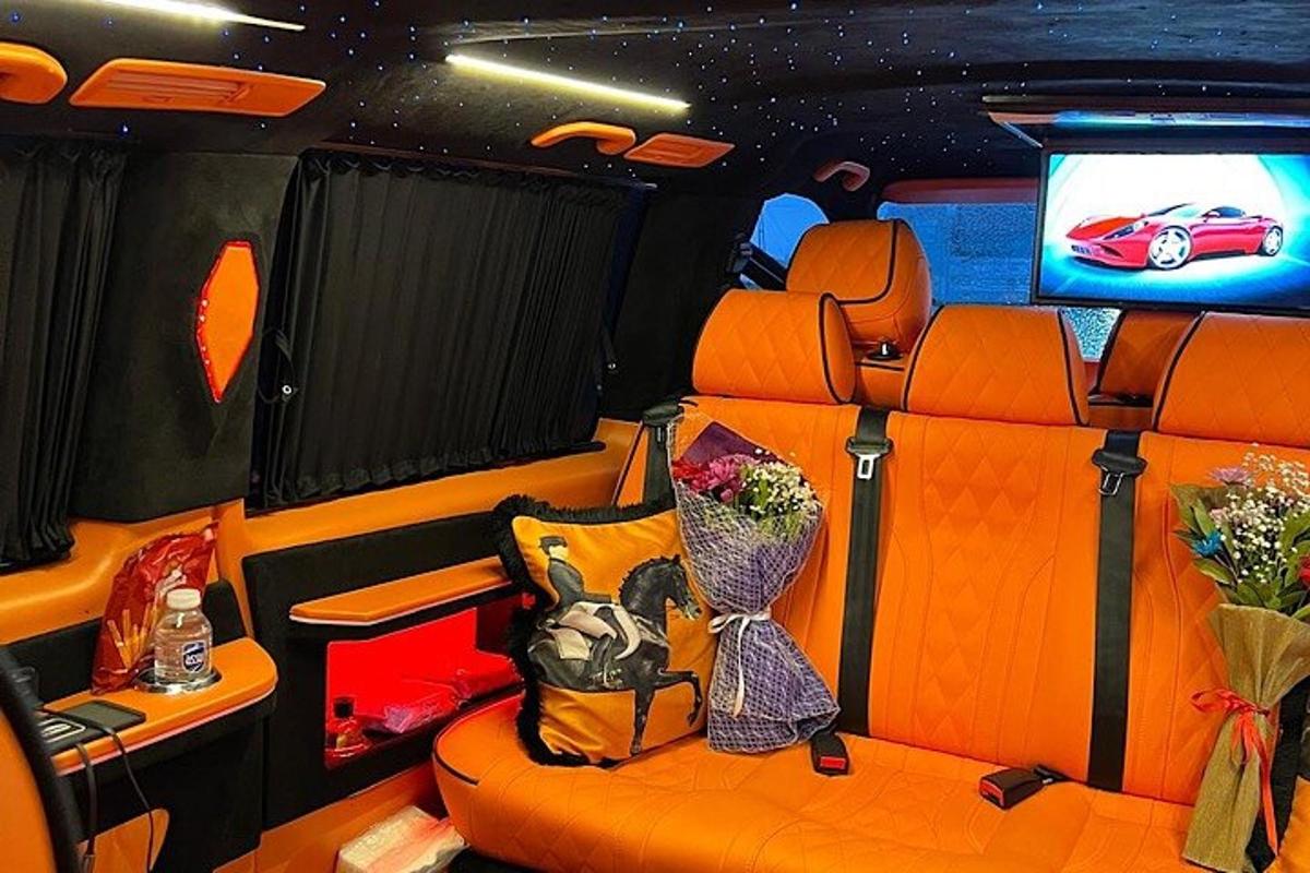 an interior view of an orange car with a television