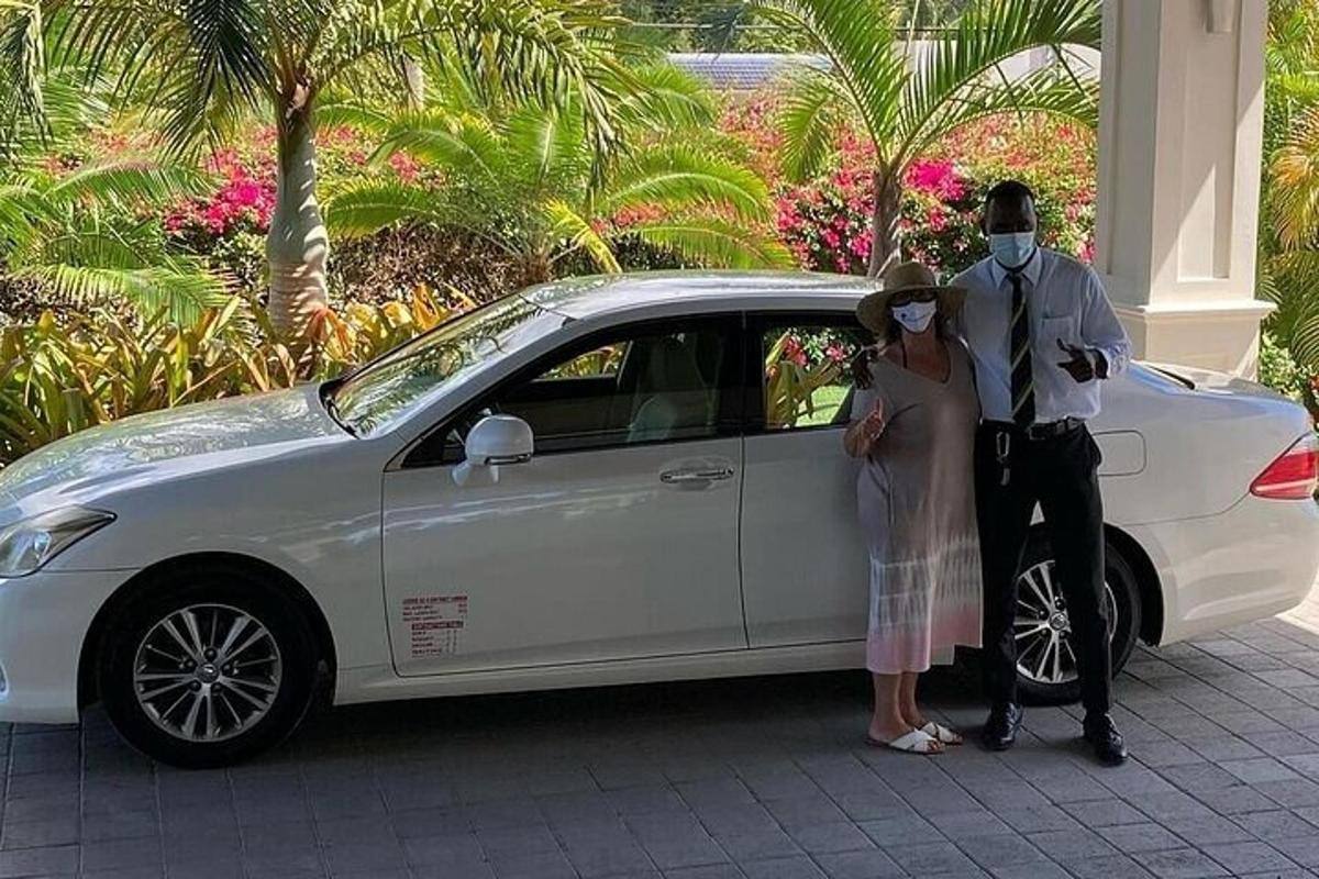 a man and a woman standing next to a white car