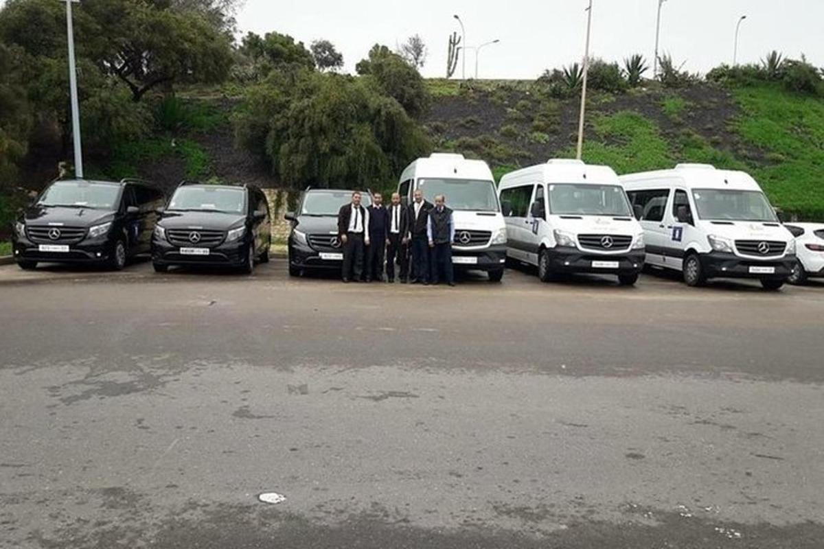 a group of men in suits standing in a parking lot