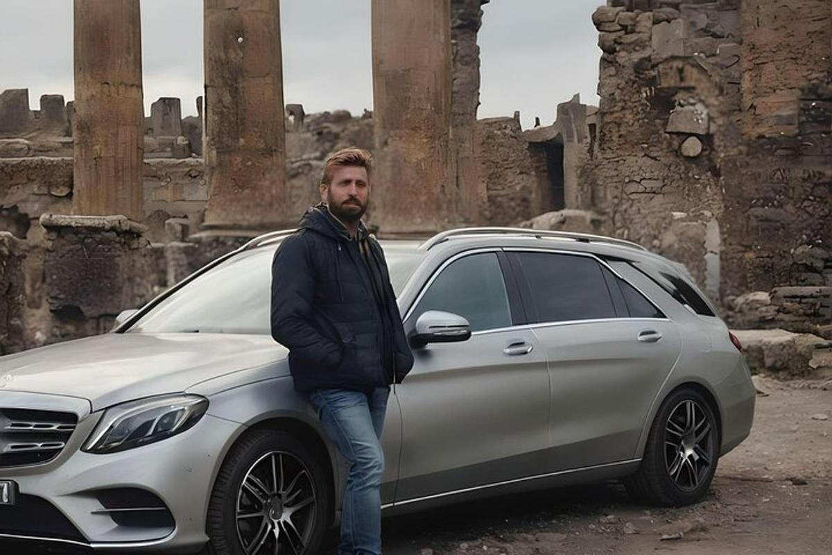 muž stojí vedľa bieleho auta