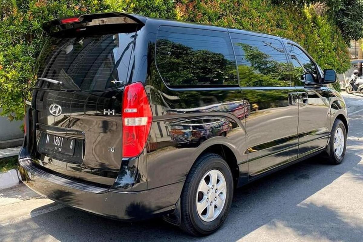 a black van parked in a parking lot with its door open