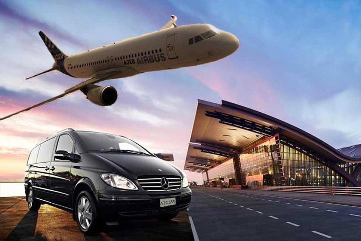 a car parked in front of an airport with an airplane