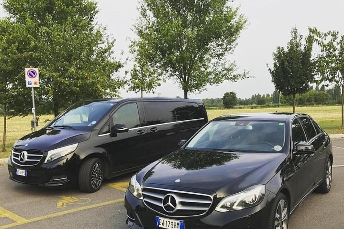 two cars parked next to each other in a parking lot