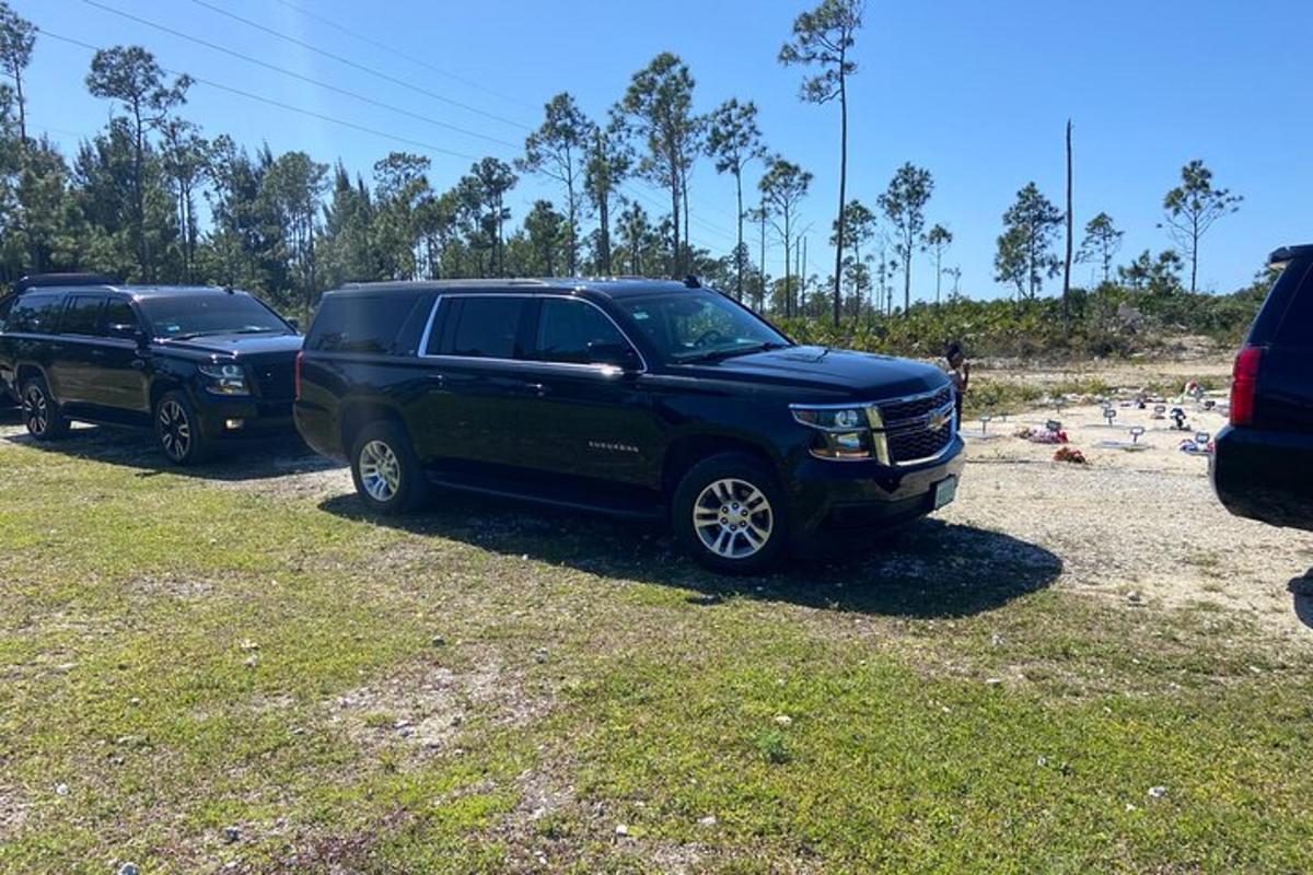 two trucks parked on a beach next to a beach