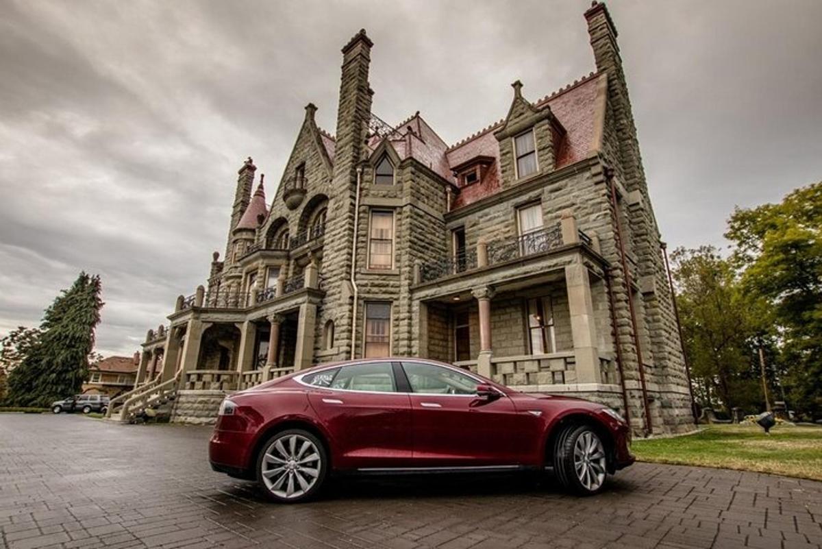 un coche rojo aparcado delante de una casa