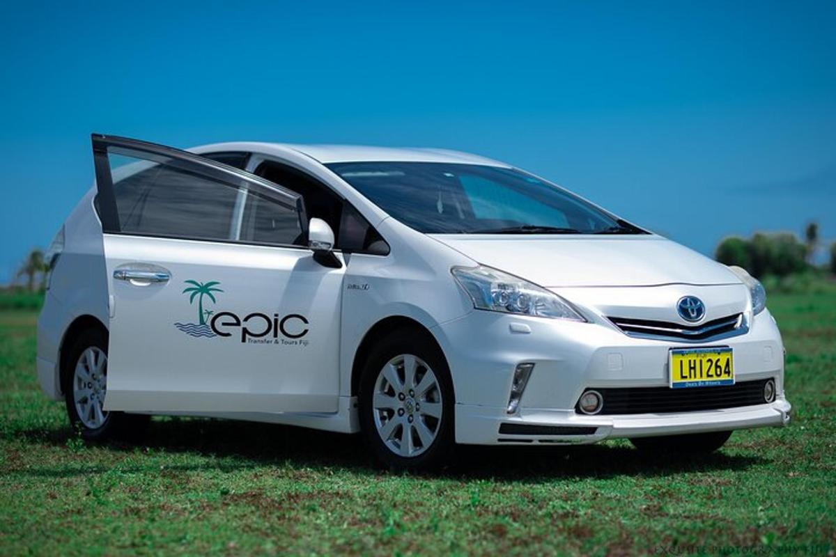 a white car parked in a grass field