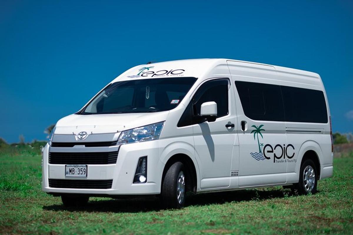 a white van parked in a field of grass