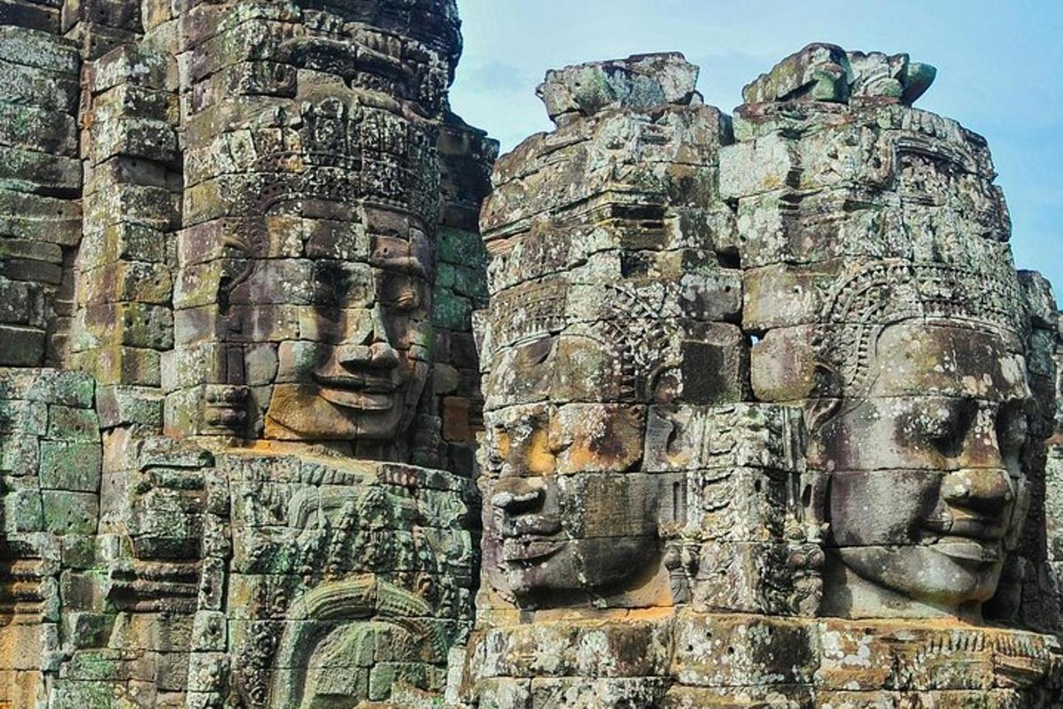 two stone faces on the side of a building