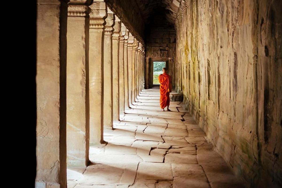 a monk walking down a hallway in a building